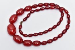 A GRADUATED BAKELITE BEAD NECKLACE, comprising of forty-three oval beads, largest measuring