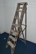 A SET OF VINTAGE WOODEN STEP LADDERS, bearing cast iron 'TRADE MARK CAJAC' mounts to both sides,