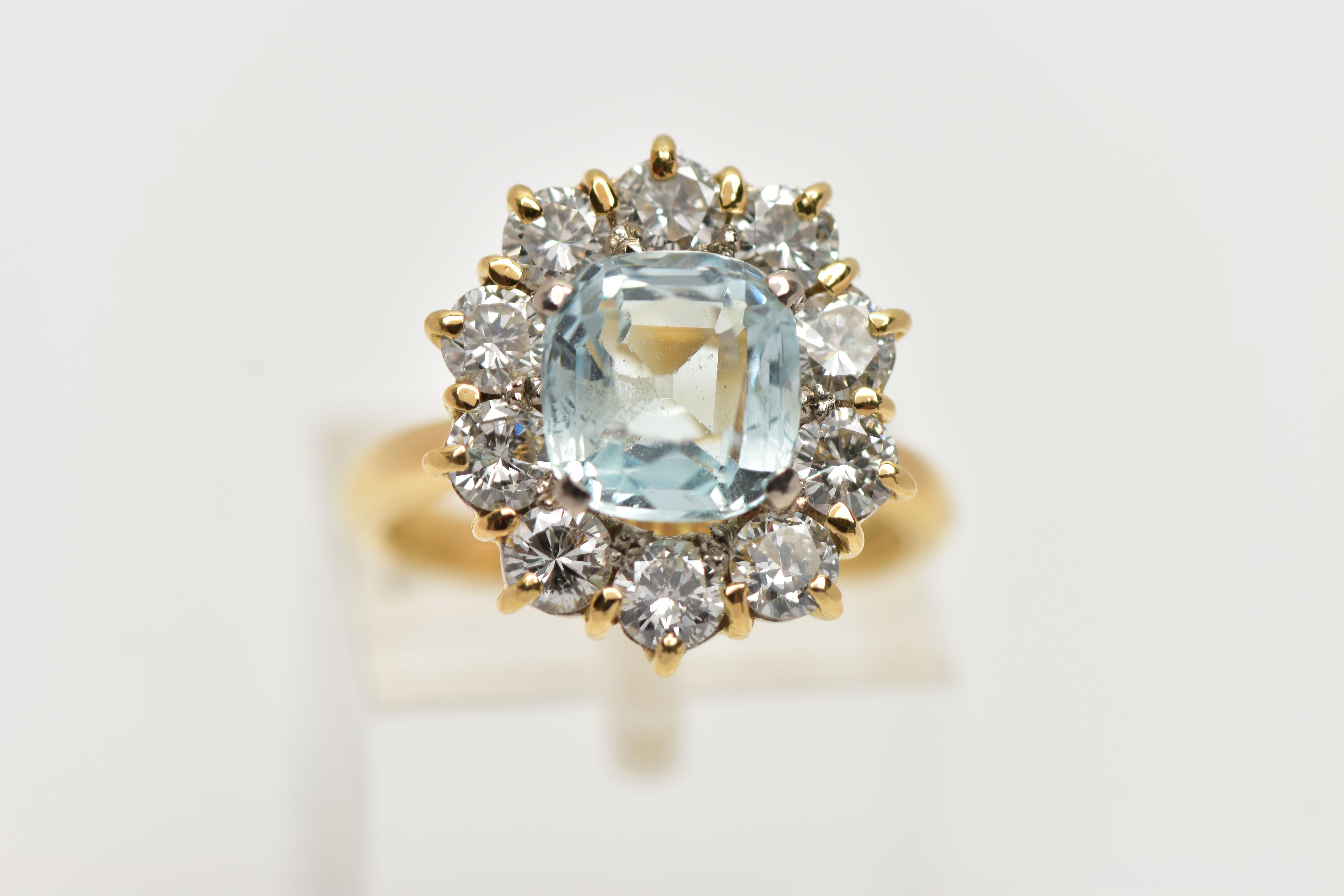 A YELLOW METAL AQUAMARINE AND DIAMOND CLUSTER RING, centring on a four claw set, cushion cut - Image 5 of 7