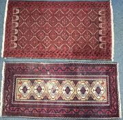 A 20TH CENTURY IRANIAN RED GEOMETRIC PATTERNED RUG, 193cm x 111cm, and a red tekke rug, 200cm x 96cm