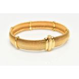 A YELLOW METAL ARTICULATED BRACELET, concaved bracelet, with polished spacers, fitted with an