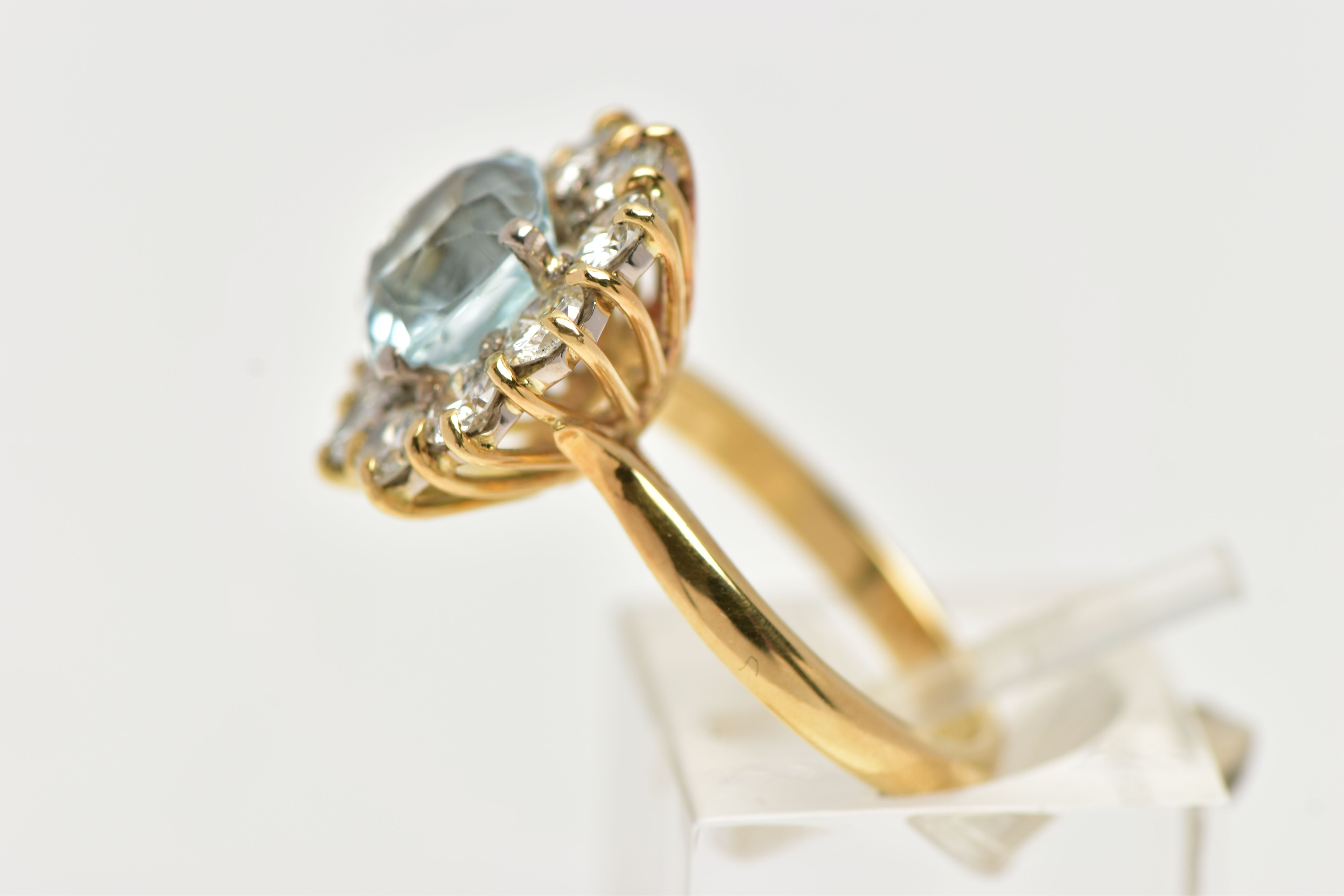 A YELLOW METAL AQUAMARINE AND DIAMOND CLUSTER RING, centring on a four claw set, cushion cut - Image 2 of 7