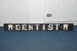 A 19TH CENTURY WOODEN BOARD LATER PAINTED AS A 'DENTIST' SIGN, with applied wooden tooth to either