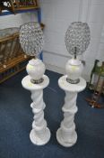 A PAIR OF ALABASTER TORCHERE STANDS, with a spiral support, height 81cm, and similar pair of table