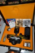 A CASED NIKON FG CAMERA AND ACCESORIES, the camera fitted with a Nikon Series E f1.8 50mm lens,