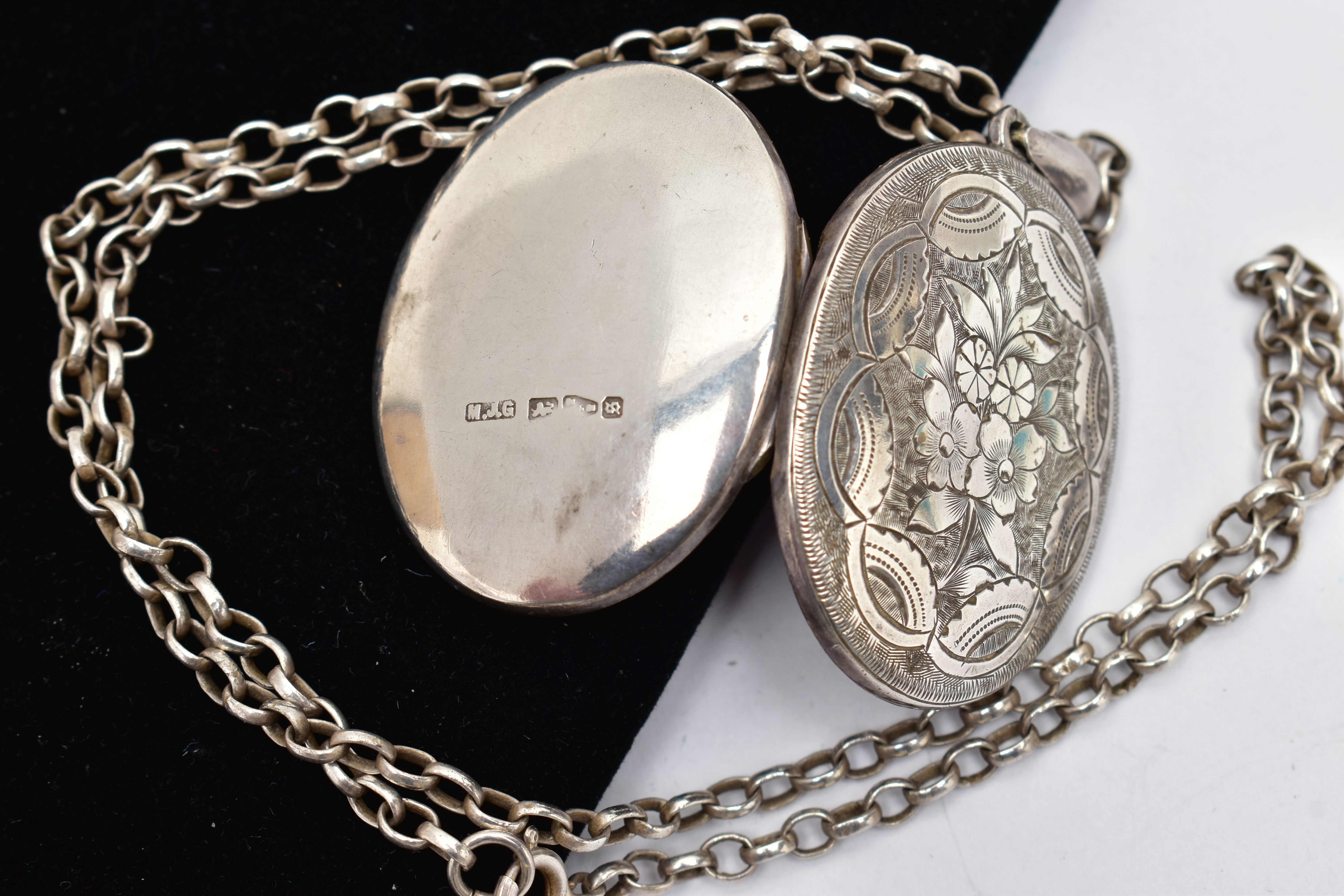 A LATE VICTORIAN SILVER LOCKET AND CHAIN, the oval locket detailed with a floral design, opens to - Image 3 of 3