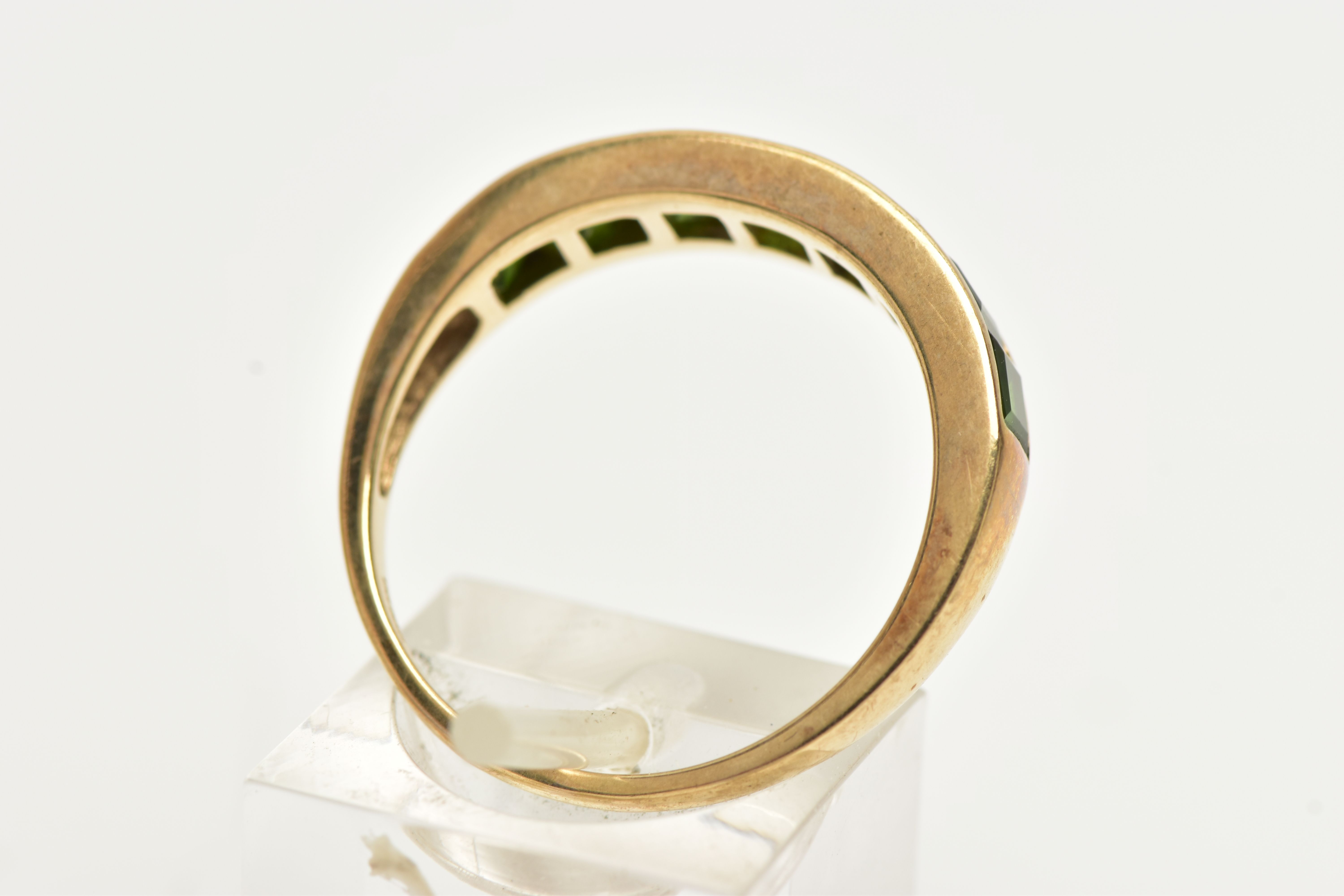 A 9CT GOLD GEM SET RING, designed with a row of channel set, graduating square cut green - Image 3 of 4