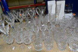 A QUANTITY OF CUT CRYSTAL DRINKING GLASSES, more than sixty glasses to include nineteen faceted