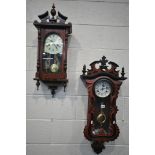 A MODERN MAHOGANY VIENNA WALL CLOCK with a wavy shaped door, height 88cm, with a winding key and