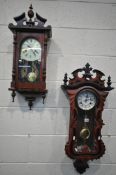 A MODERN MAHOGANY VIENNA WALL CLOCK with a wavy shaped door, height 88cm, with a winding key and