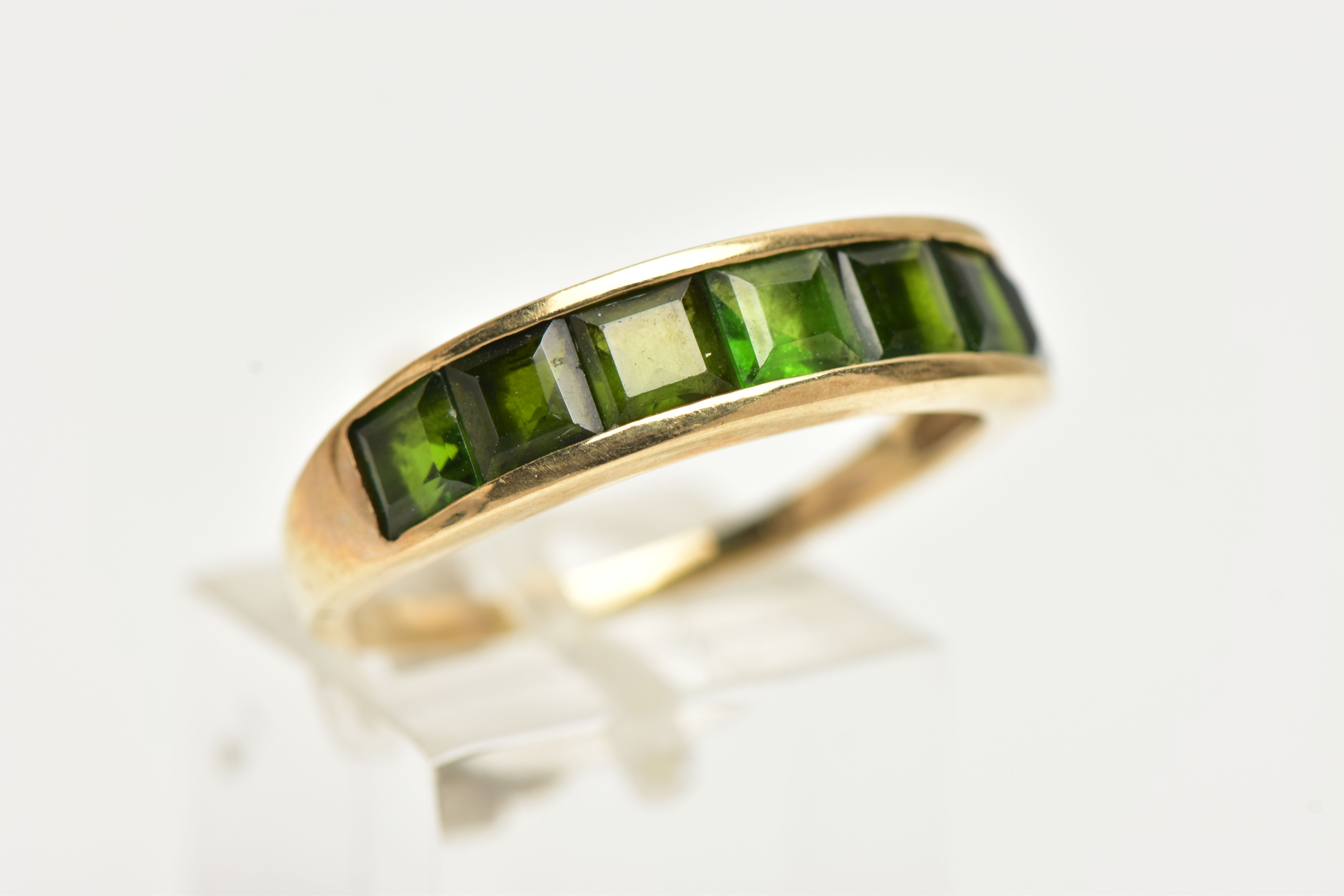 A 9CT GOLD GEM SET RING, designed with a row of channel set, graduating square cut green - Image 4 of 4