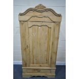 A FRENCH PINE PANELLED SINGLE DOOR ARMOIRE, with a foliate shaped cornice, and a single drawer,