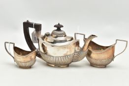 AN EDWARDIAN SILVER THREE PIECE BACHELOR'S TEA SET OF OVAL FORM, reeded decoration to the lower