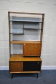 A MID CENTURY G PLAN TOLA AND BLACK ROOM DIVIDER BOOKCASE, with four sized shelves, a fall front