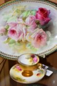 A ROYAL WORCESTER TEACUP AND SAUCER, AND A ROYAL DOULTON BOWL, PAINTED WITH ROSES, the small