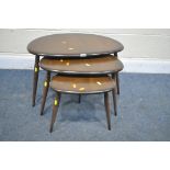 A DARK ERCOL ELM AND BEECH NEST OF THREE PEBBLE TALBES, largest table width 66cm x depth 44cm x