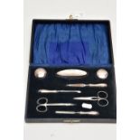 AN EARLY 20TH CENTURY CASED SILVER MANICURE SET, case opens to reveal two small glass jars with