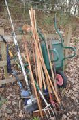A COLLECTION OF GARDEN TOOLS to include spade, fork, brush, wheelbarrow etc