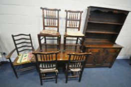 A 20TH CENTURY OAK DINING SUITE, comprising a draw leaf dining table, on twin acorn supports,
