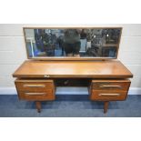 A MID CENTURY G PLAN FRESCO TEAK DRESSING TABLE, with a large rectangular mirror, a central slide,