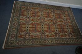 A TURKISH TABRIZ RUG, with a repeating geometric design, red field, an multi strap border, 235cm x