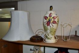 A MOORCROFT POTTERY TABLE LAMP, in the Columbine pattern on a cream ground, with loose wooden base