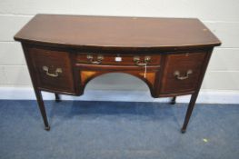 AN EDWARDIAN MAHOGANY AND INLAID BOW FRONT DESK, with three various drawers, on square tapering
