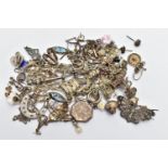 AN ASSORTMENT OF WHITE METAL JEWELLERY, to include a Scottish brooch, chain necklaces, two charm