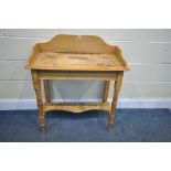 A VICTORIAN PINE WASHSTAND, with a raised back, on block and turned legs, united by an undershelf,
