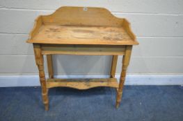 A VICTORIAN PINE WASHSTAND, with a raised back, on block and turned legs, united by an undershelf,