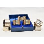 A PAIR OF CASED GEORGE V SILVER CIRCULAR NAPKIN RINGS AND FIVE OTHER SILVER NAPKIN RINGS, the