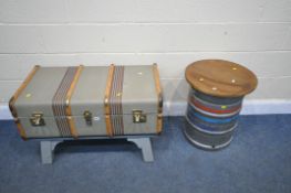 A BESPOKE COFFEE TABLE, made from a vintage canvass traveling trunk, on painted wooden legs,