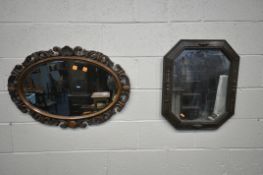 AN EARLY 20TH CENTURY OPEN FOLIATE SCROLLED OVAL WALL MIRROR, with bevelled plate, 83cm x 57cm,