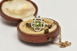 A YELLOW METAL, ENAMEL BROOCH, small brooch displaying a flower set with a central seed pearl,