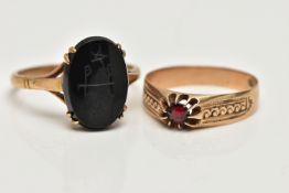 TWO GEM SET RINGS, the first an oval onyx with carved detail, prong set in yellow metal, trifurcated