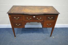 AN EDWARDIAN MAHOGANY AND INLAID BOW FRONT DESK, with a distressed leather writing surface, five