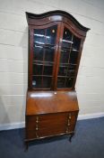AN EARLY 20TH CENTURY MAHOGANY BUREAU BOOKCASE, the domed top with two glazed doors, enclosing three