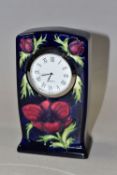 A MOORCROFT POTTERY MANTEL CLOCK, decorated in the Anemone pattern on a dark blue ground, quartz