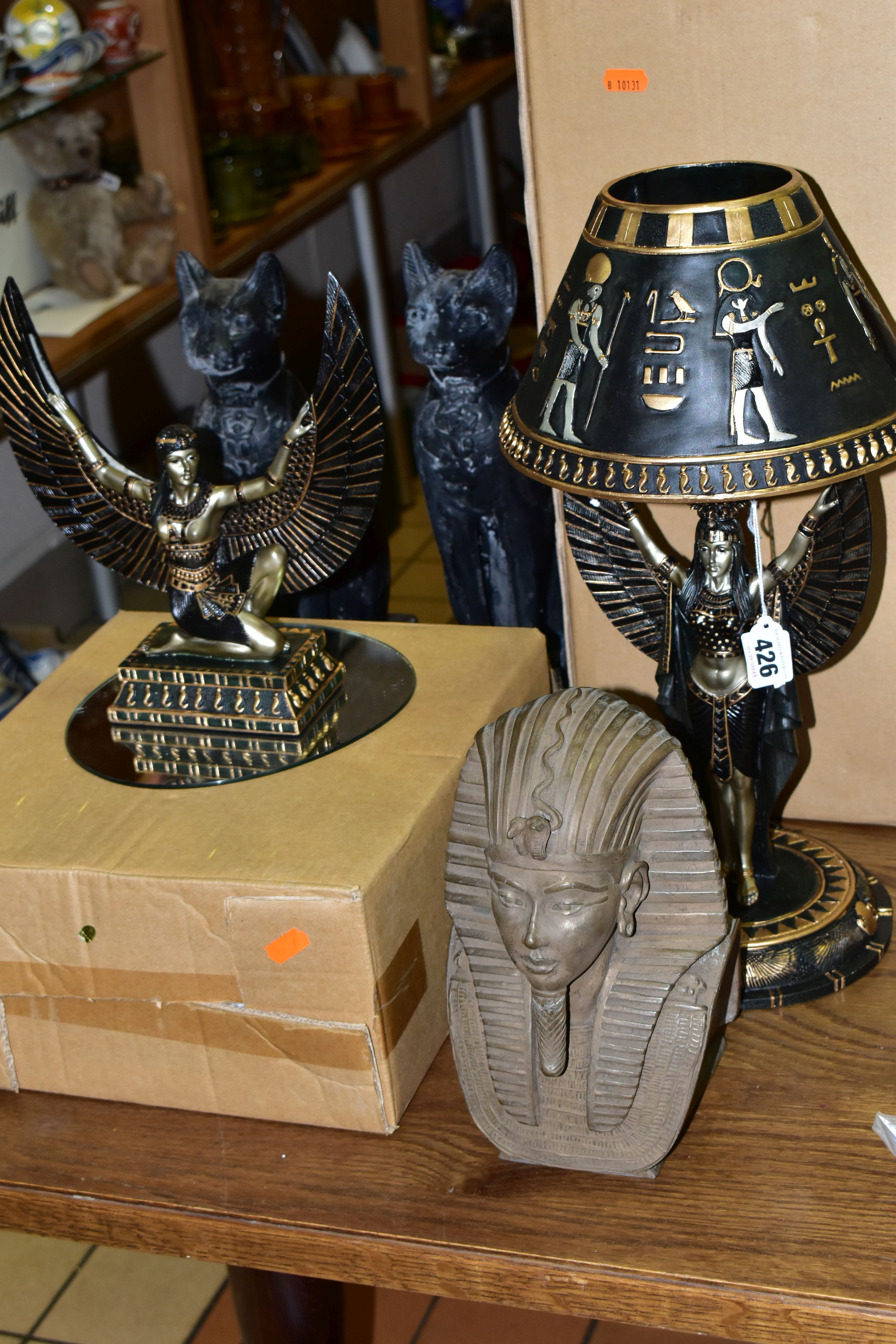 A GROUP OF EGYPTIAN THEMED HOMEWARES, comprising a boxed resin figure of a kneeling woman wearing