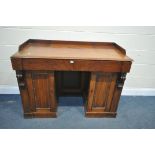 A VICTORIAN MAHOGANY PEDESTAL SIDEBOARD, with a slight raised back, two drawers, above two