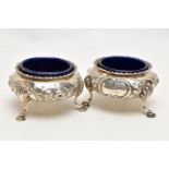 A PAIR OF MID VICTORAIN SILVER SALTS, each of a cauldron form with an embossed floral design,