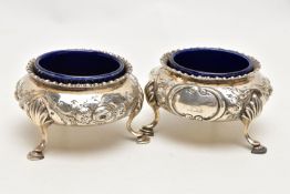 A PAIR OF MID VICTORAIN SILVER SALTS, each of a cauldron form with an embossed floral design,