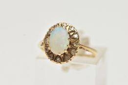 A YELLOW METAL, OPAL AND DIAMOND CLUSTER RING, of an oval form, centring on an oval opal cabochon,