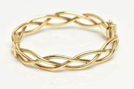 A 9CT GOLD HINGED BANGLE, openwork weaved bangle, fitted with a push piece clasp and two figure of