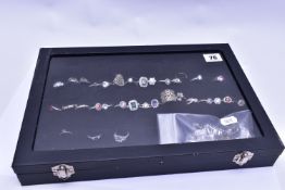 A RING DISPLAY BOX WITH RINGS, to include thirty-four white metal rings of various designs all