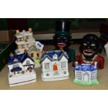 A COLLECTION OF MONEY BOXES, comprising four ceramic Staffordshire/Staffordshire-style money boxes