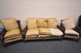 AN EARLY 20TH CENTURY MAHOGANY BERGERE FRAMED SUITE, comprising a settee, length 175cm, and a pair