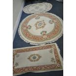 A CHINESE WOOLLEN CIRCULAR RUG, diameter 160cm, and two other small woollen rugs, and two table