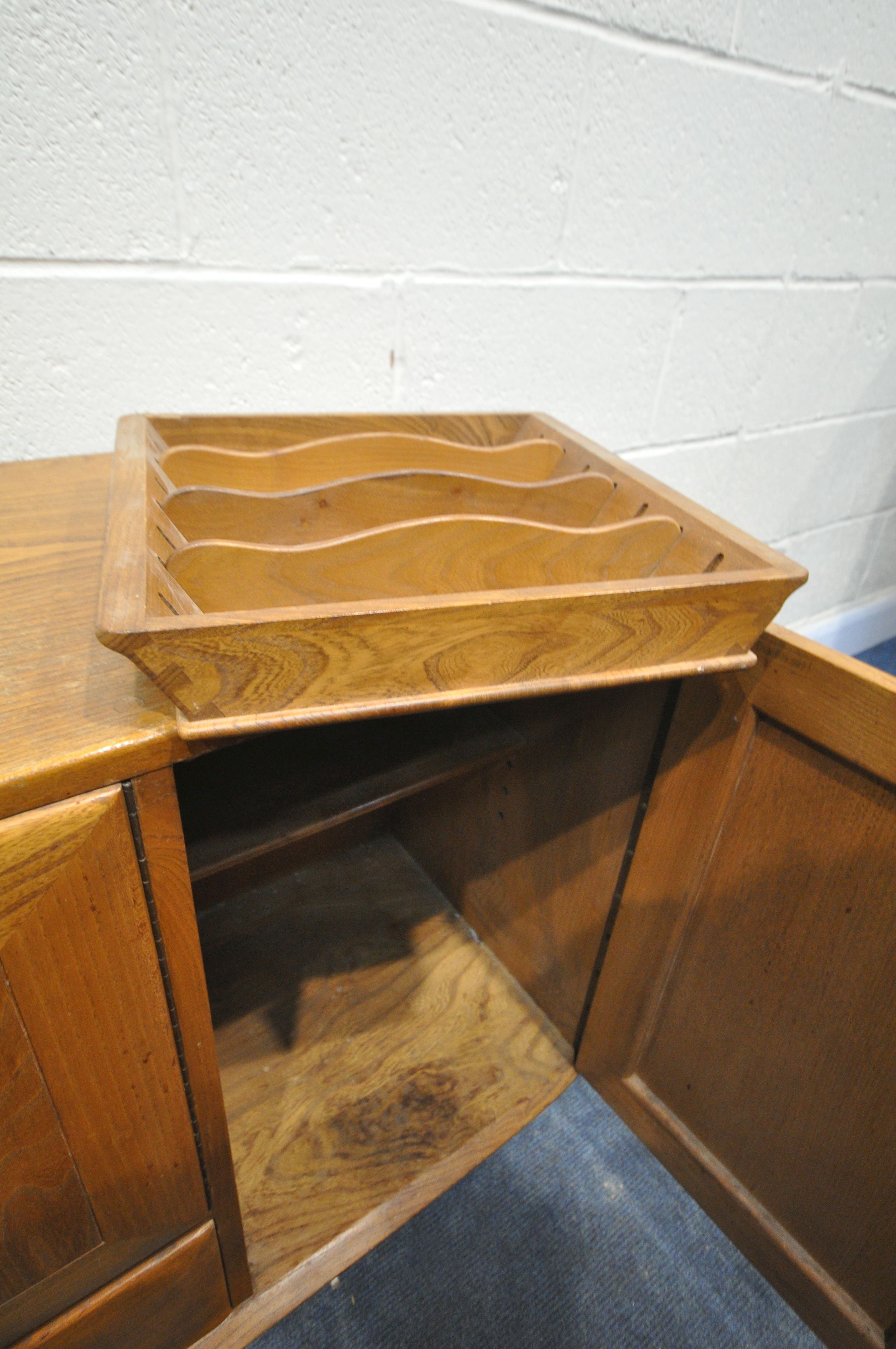 AN ERCOL BLONDE ELM SIDEBOARD, with double cupboard doors over a single drawer flanked by a single - Image 4 of 5