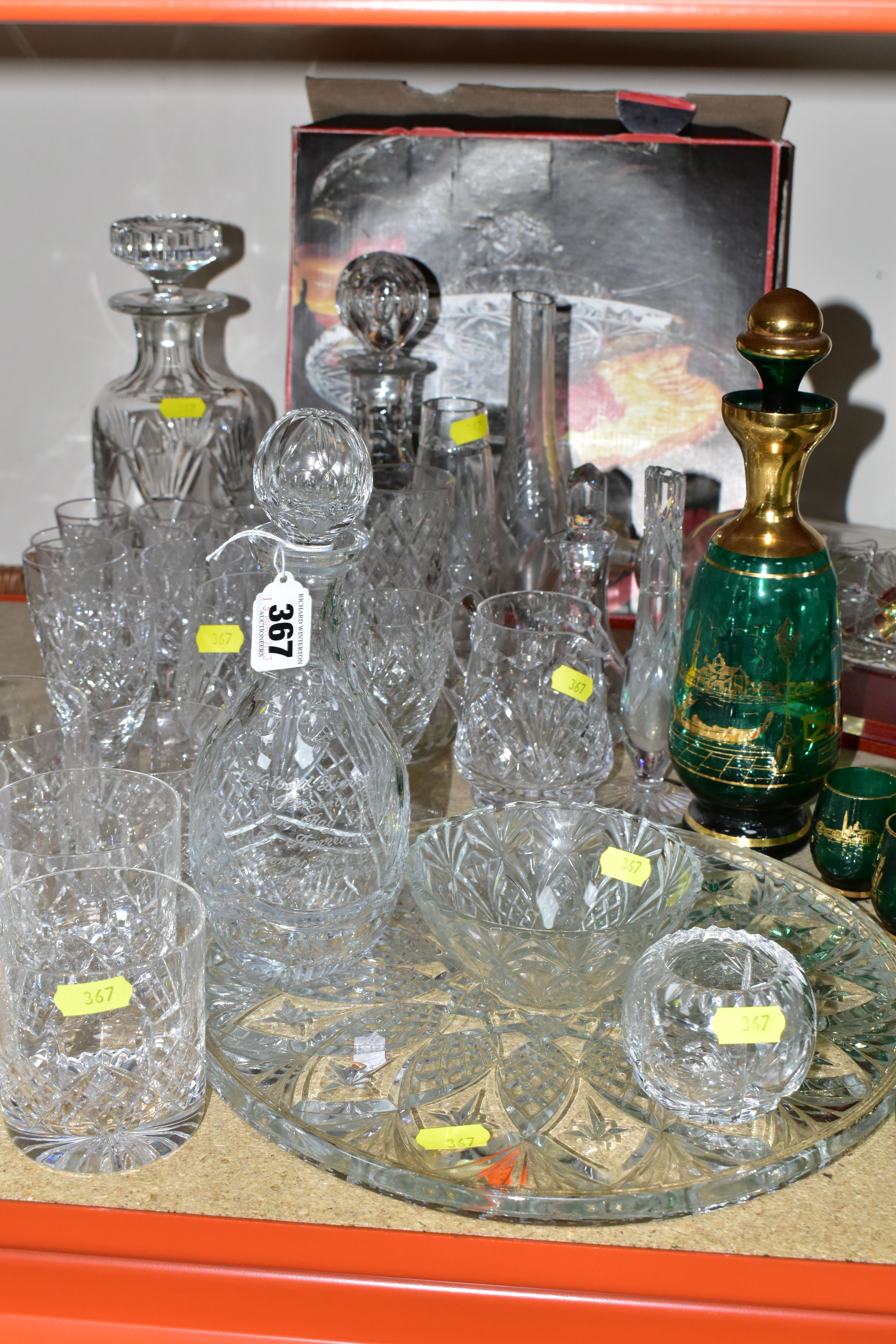 A GROUP OF CUT CRYSTAL AND COLOURED GLASS, comprising three cut crystal decanters, oil decanter, six